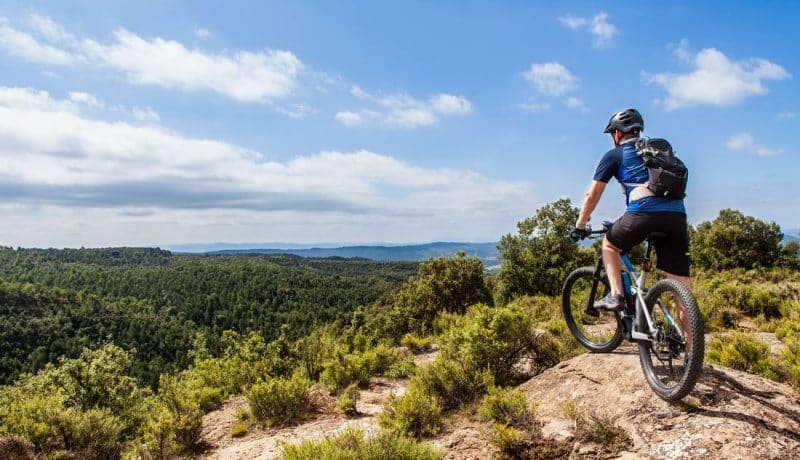 Male ebike rider taking a break and enjoying the beautiful landscape